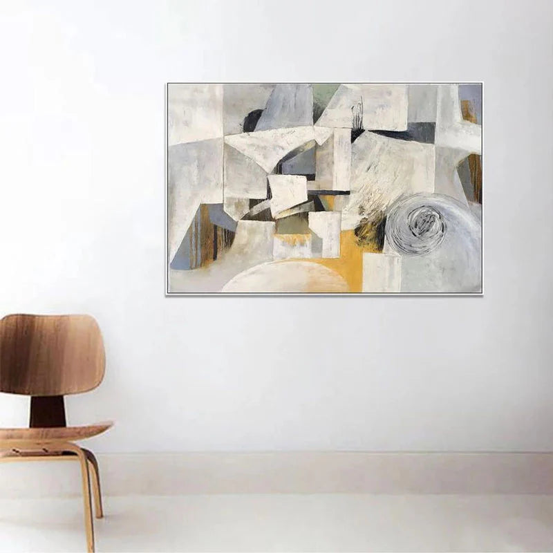 Abstract art painting on a white wall with a wooden chair in the foreground