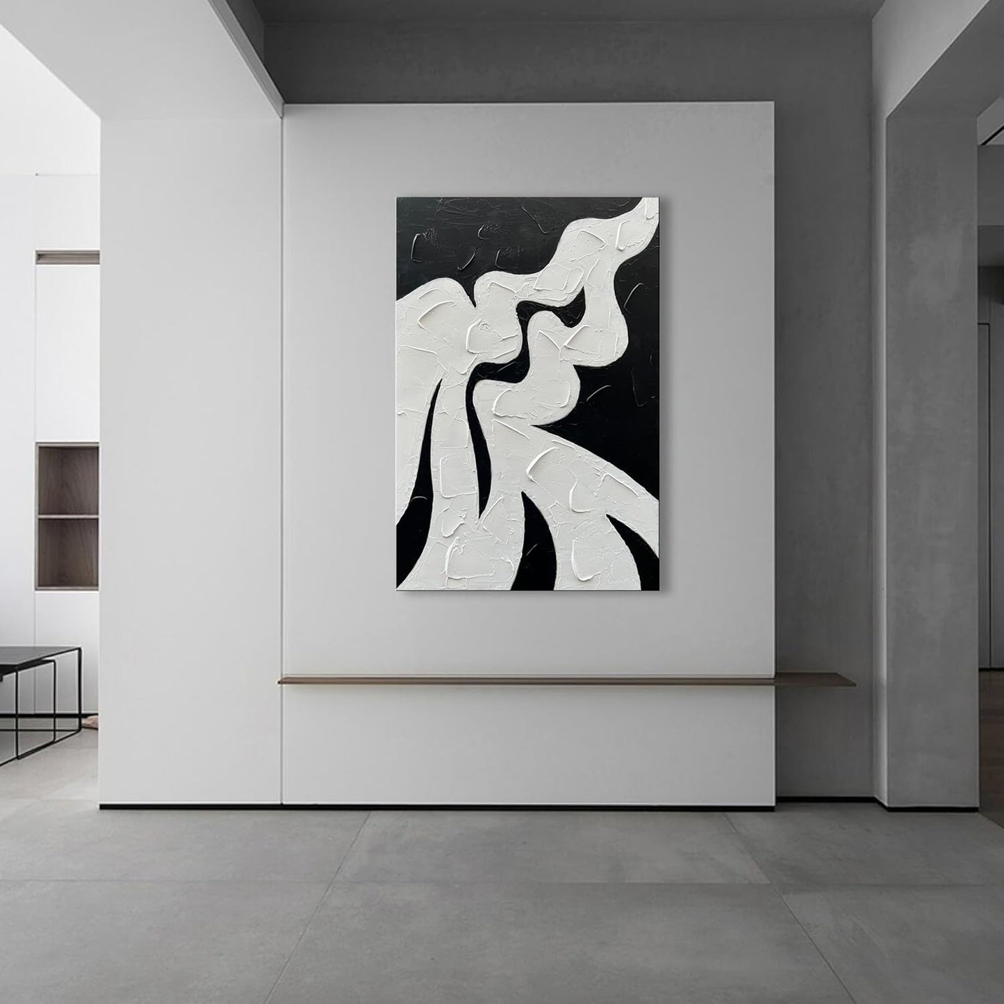 Abstract black and white artwork on a wall in a modern interior setting