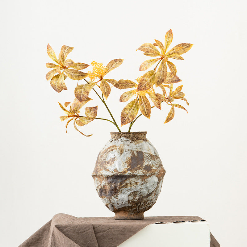 Decorative vase with dried flowers on a neutral background