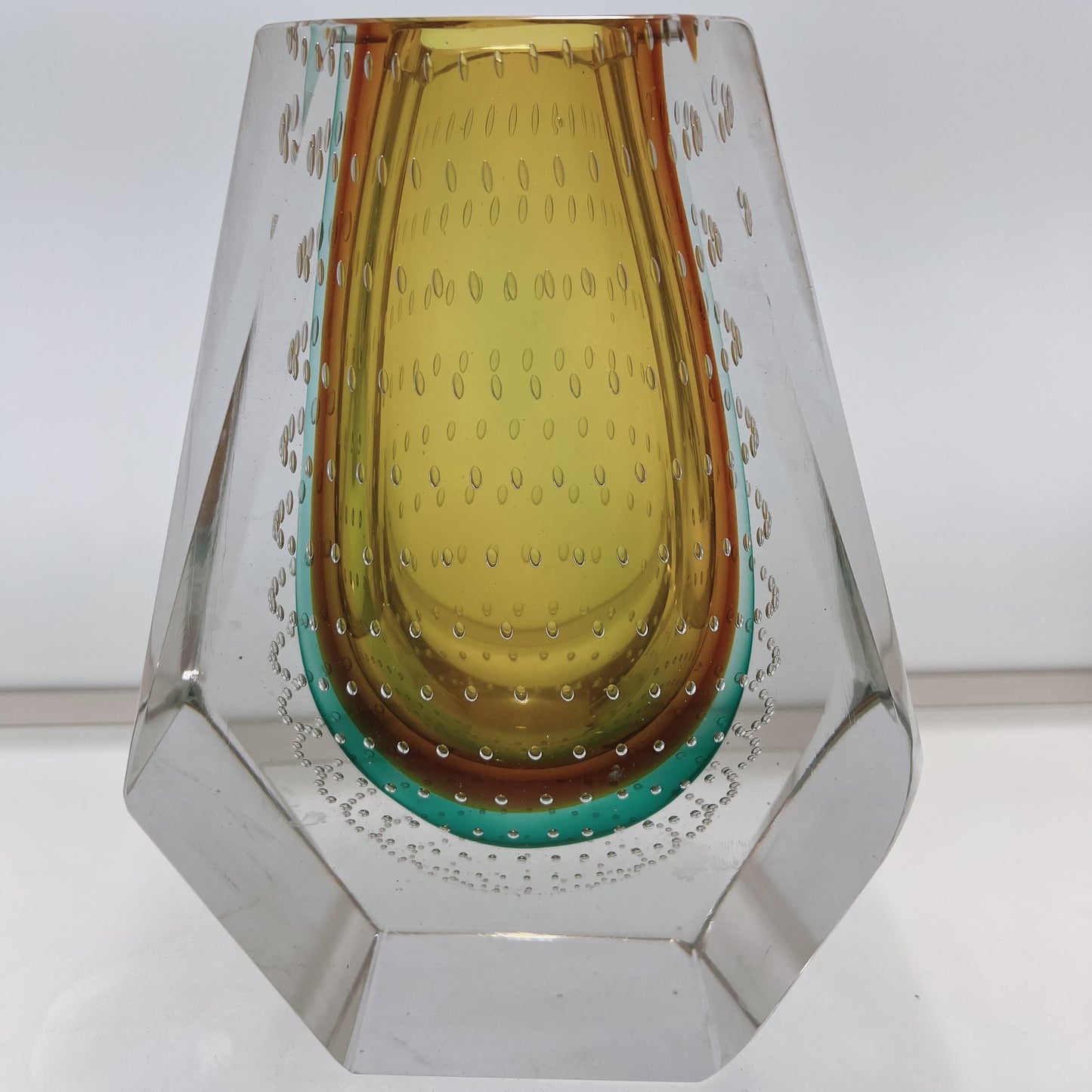 Decorative glass vase with a geometric design on a white background
