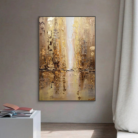 Abstract painting in a gold and brown color scheme on a gray wall.