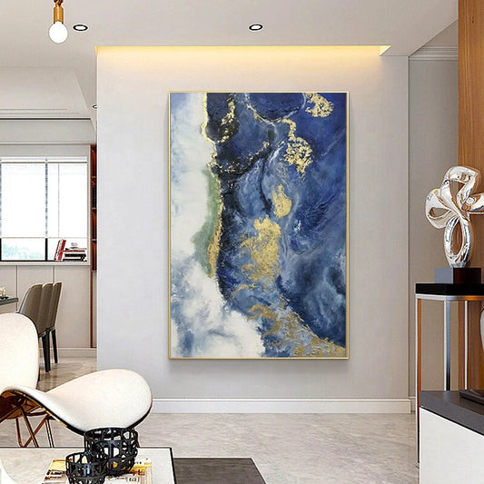 Abstract art piece with blue and gold tones in a modern living room setting.