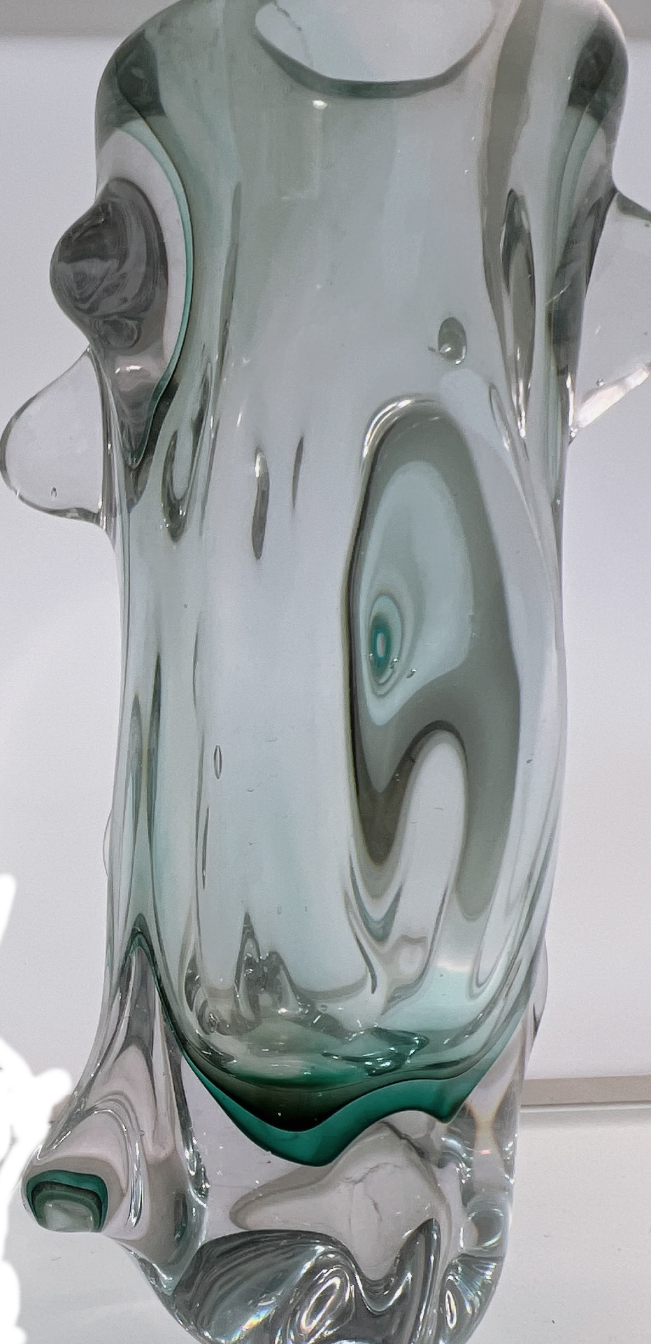 Glass vase with swirling patterns on a white background