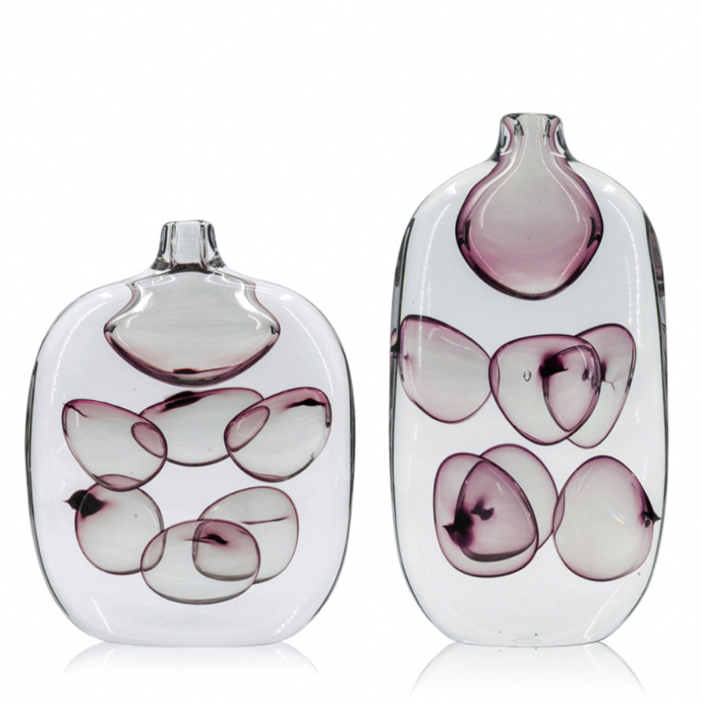 Two glass vases with purple and white abstract designs on a white background