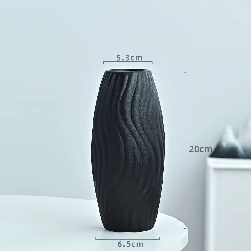 Black textured vase with measurements on a light gray background
