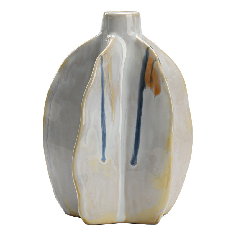 Ceramic vase with gray, beige, and blue abstract design on a white background