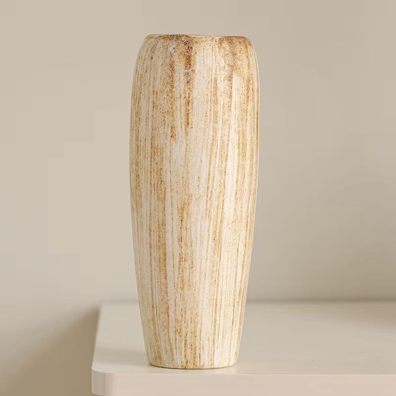 Decorative vase with a striped pattern on a neutral background