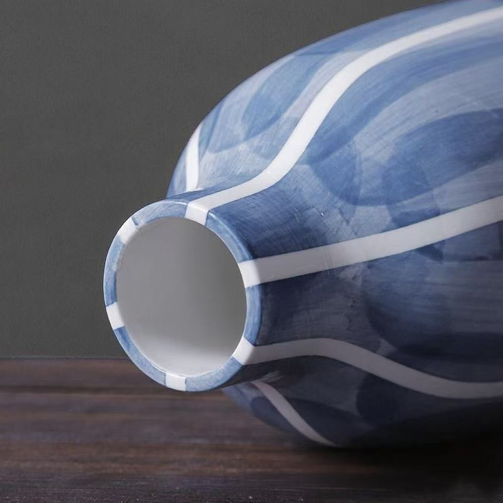 Blue and white ceramic vase on a dark surface with a gray background