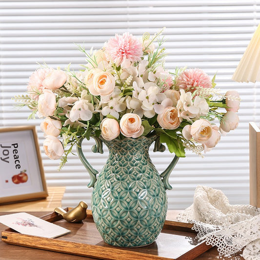 Decorative pineapple-shaped vase with flowers on a wooden surface