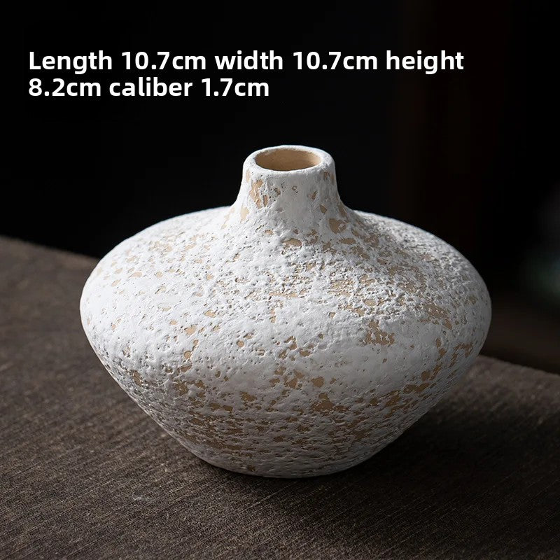 White textured vase on a dark surface with dimensions displayed