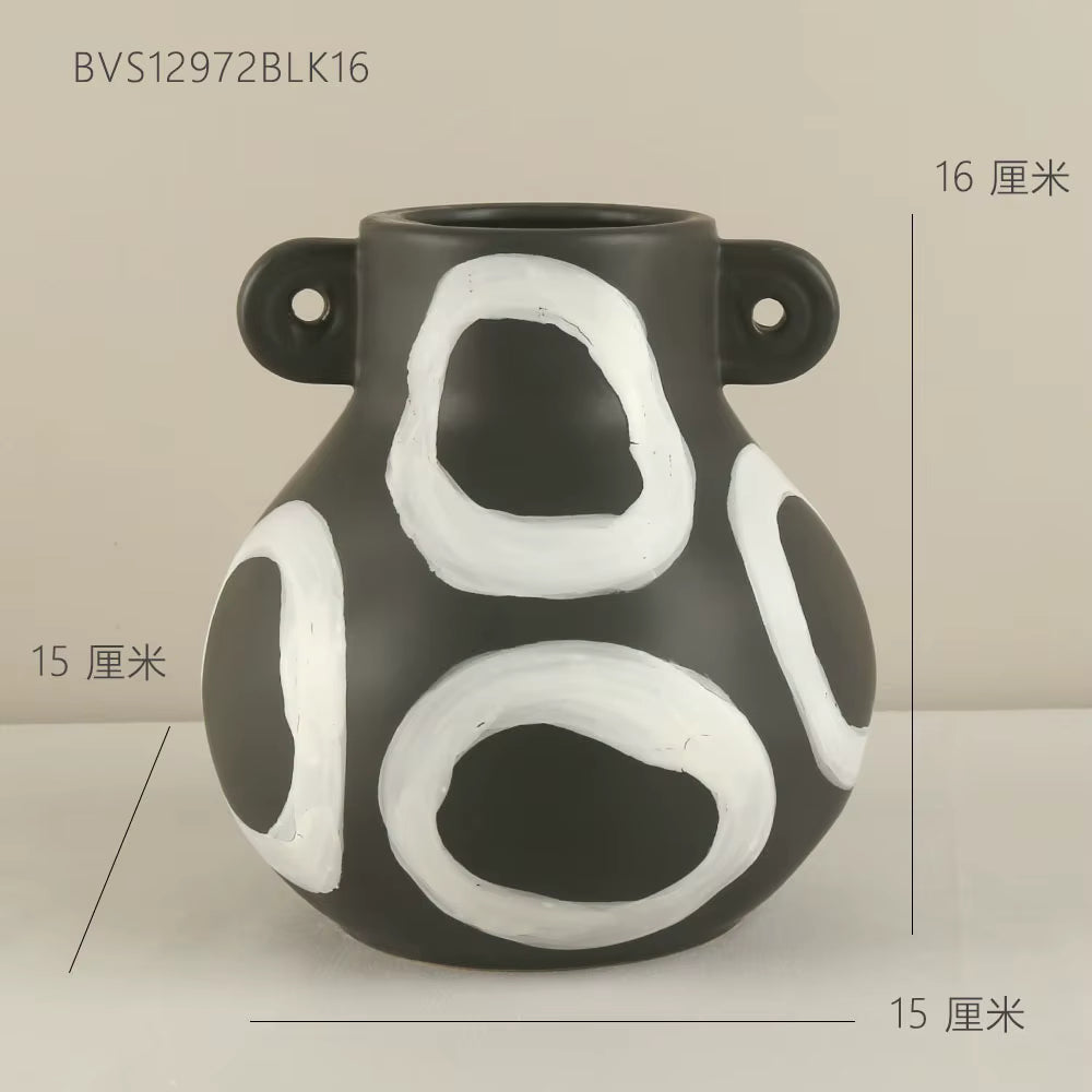Black and white ceramic vase with measurements on a beige background