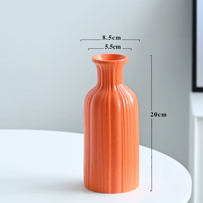 Orange textured vase on a white surface with dimensions indicated