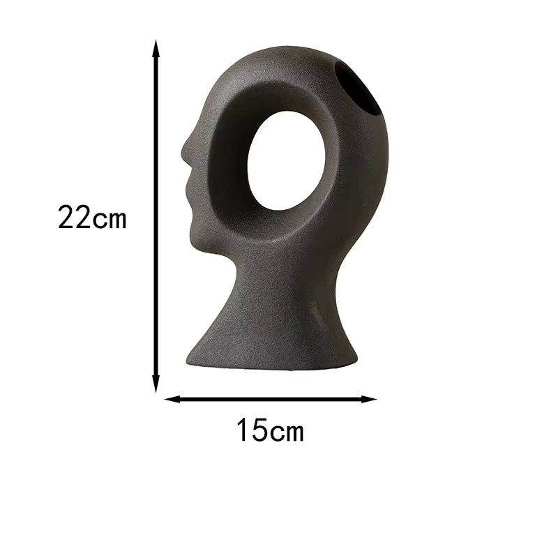 Gray sculpture of a face with dimensions labeled on a white background