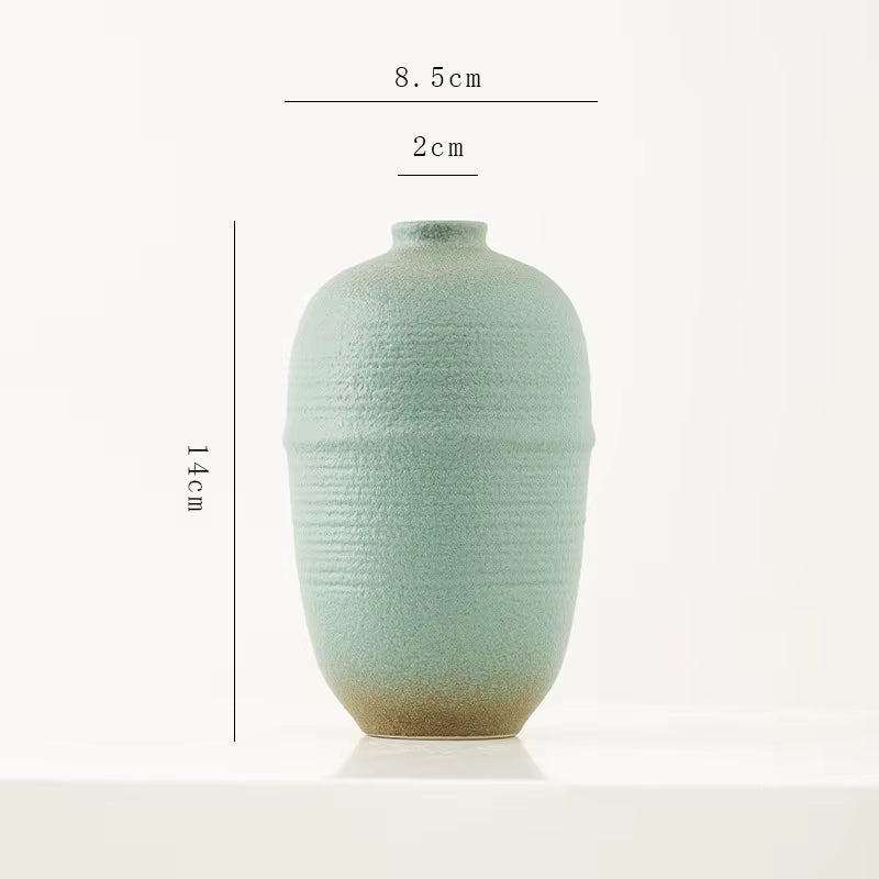 Light green ceramic vase with dimensions on a white background