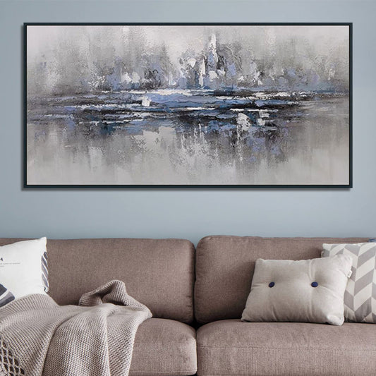 Abstract painting on a wall above a brown sofa with decorative pillows.