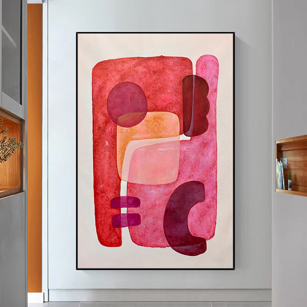 Abstract art piece with pink and red colors in a modern interior setting.