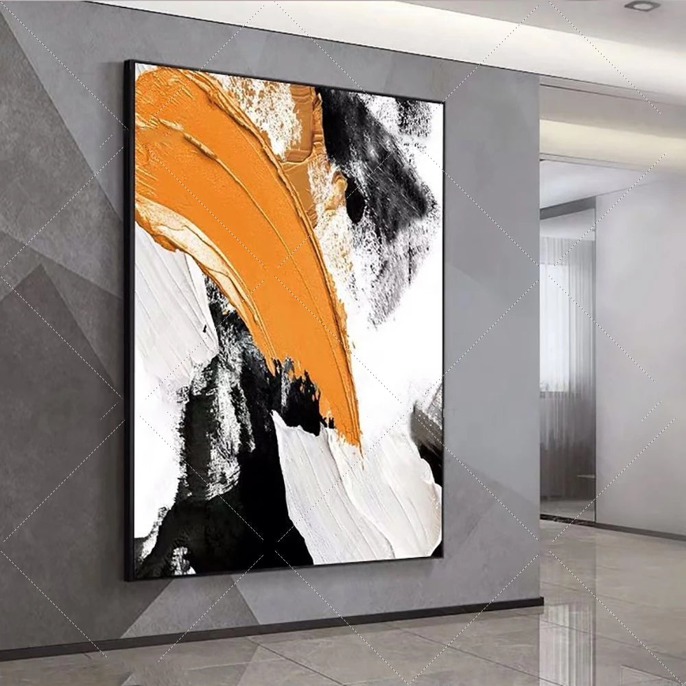 Abstract art piece with orange, black, and white colors on a gray wall.