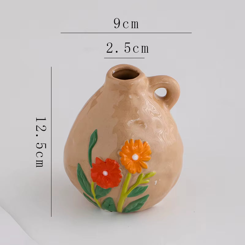 Ceramic vase with floral design and measurements on a white background