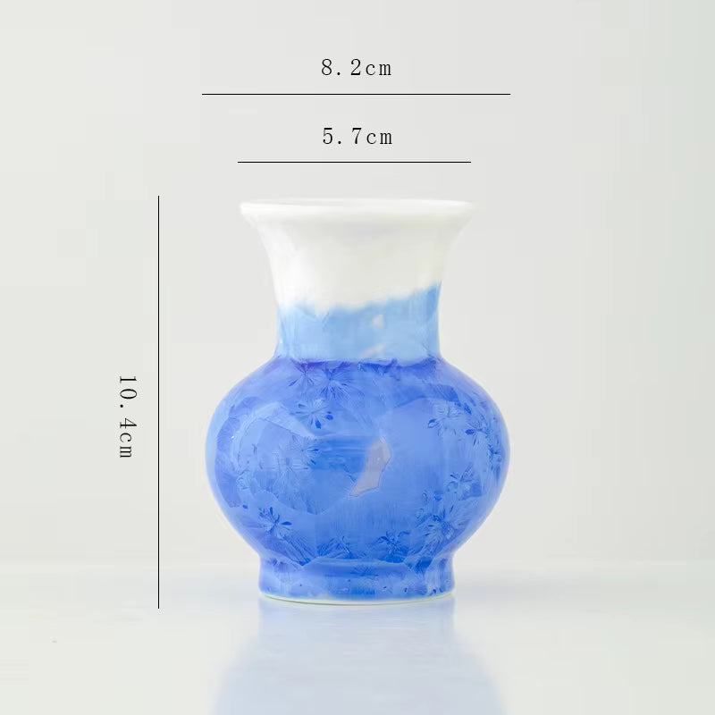 Blue vase with measurements on a light gray background