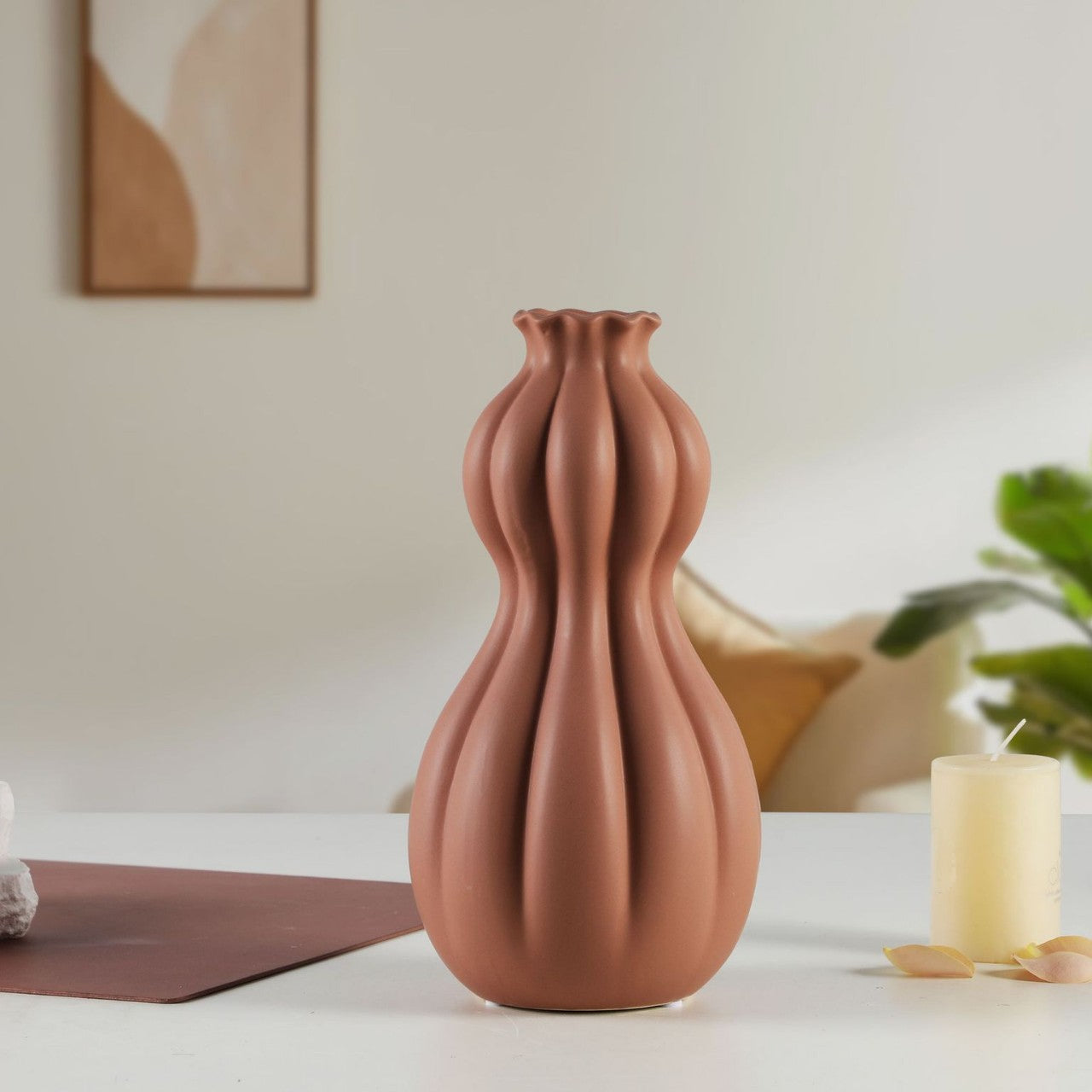 Terracotta-colored vase on a table with a neutral background