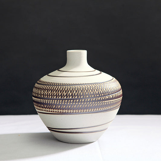 Ceramic vase with decorative patterns on a black background