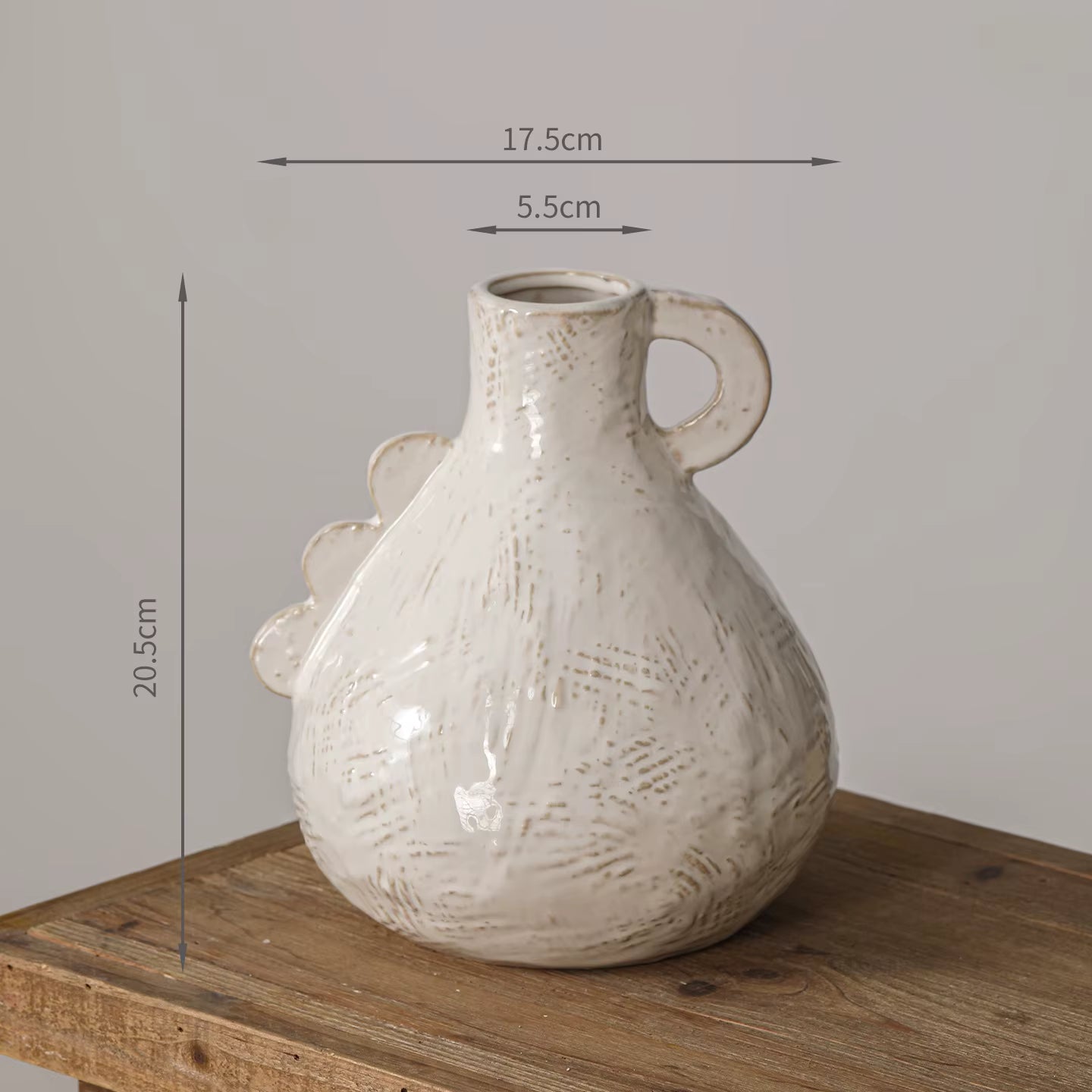 White textured vase on a wooden surface with dimensions indicated