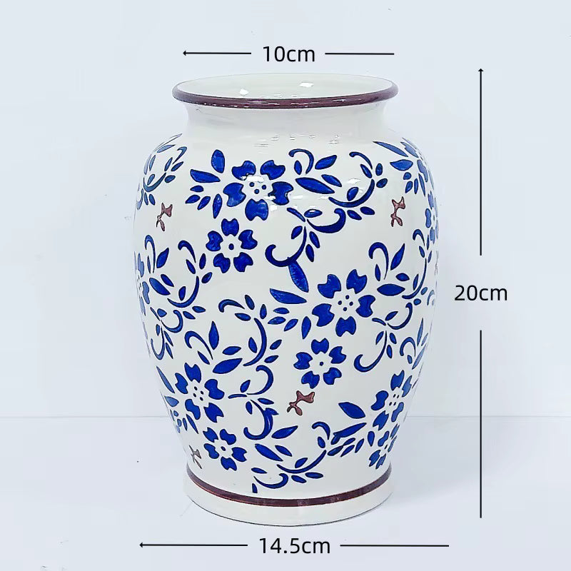 Ceramic vase with blue floral patterns and measurements on a white background