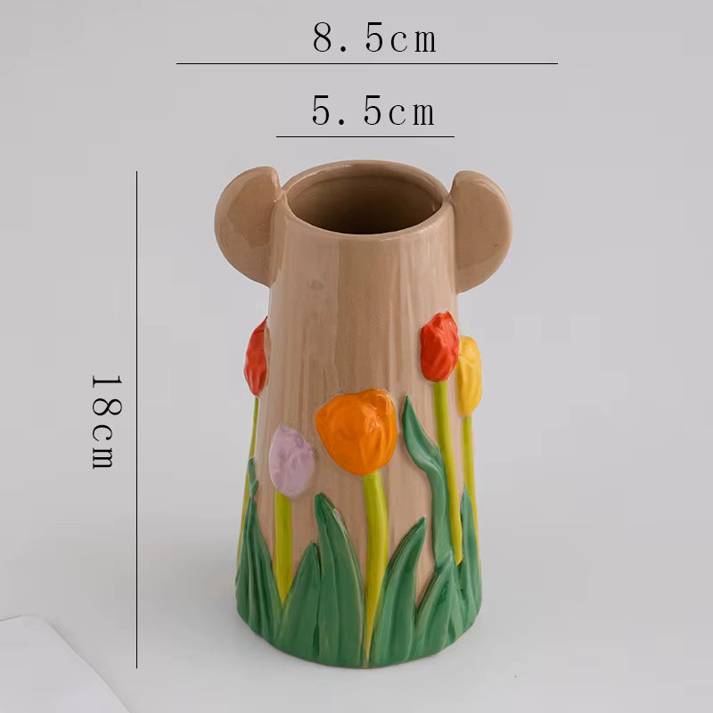Decorative vase with floral design and measurements on a white background