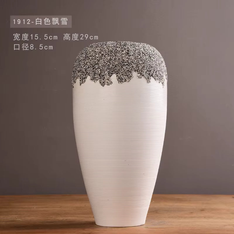 White vase with decorative top on a wooden surface and brown background