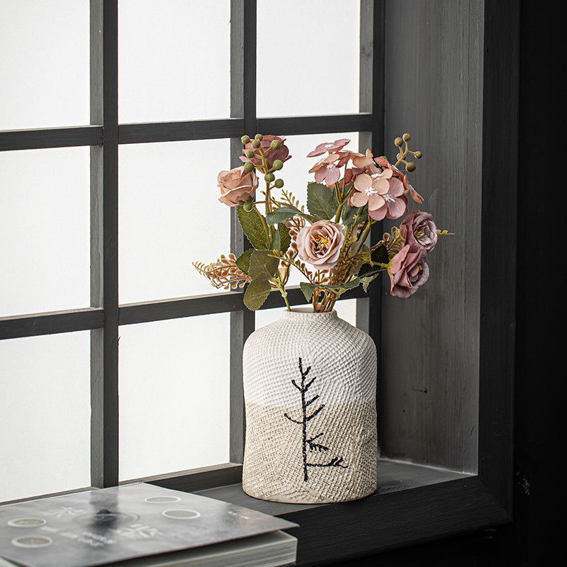 Decorative vase with flowers on a windowsill
