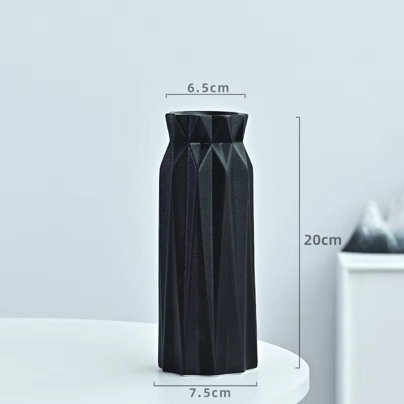 Black geometric vase with measurements on a light gray background