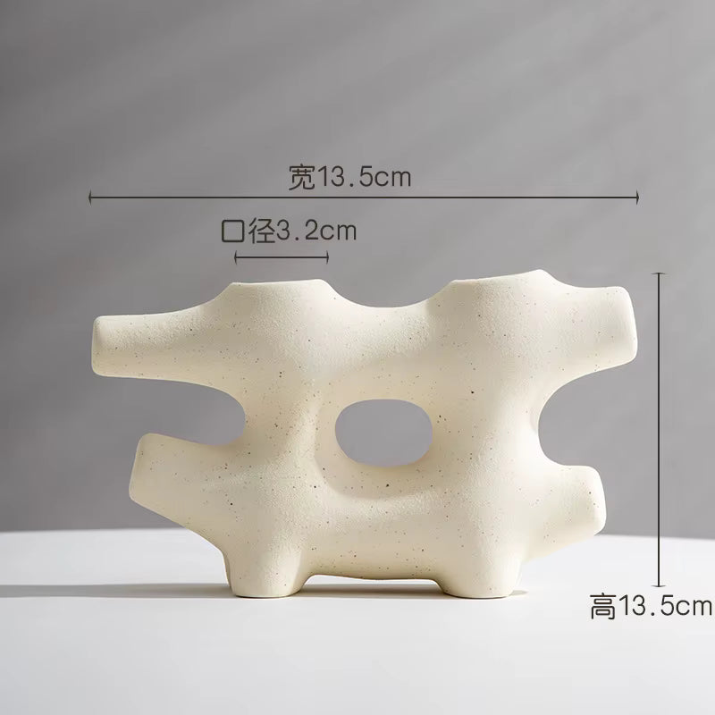 Abstract ceramic sculpture with dimensions indicated on a gray background