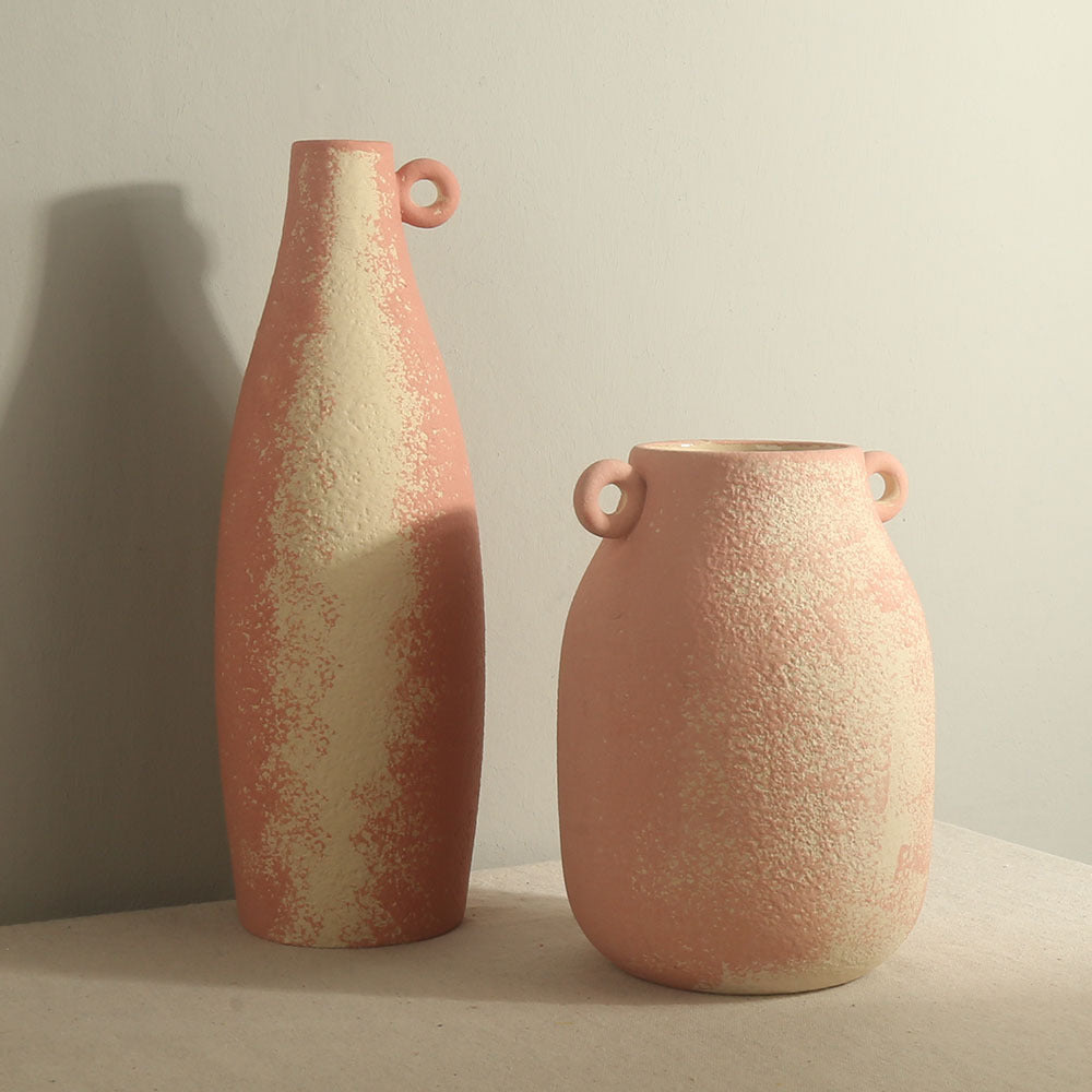 Two textured ceramic vases on a neutral background