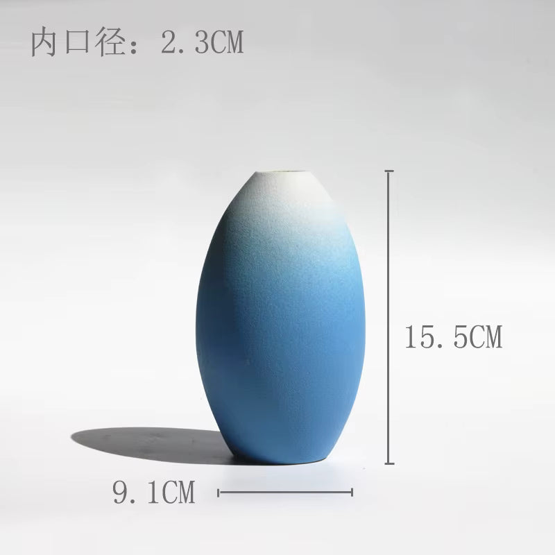 Blue ceramic vase with measurements on a white background