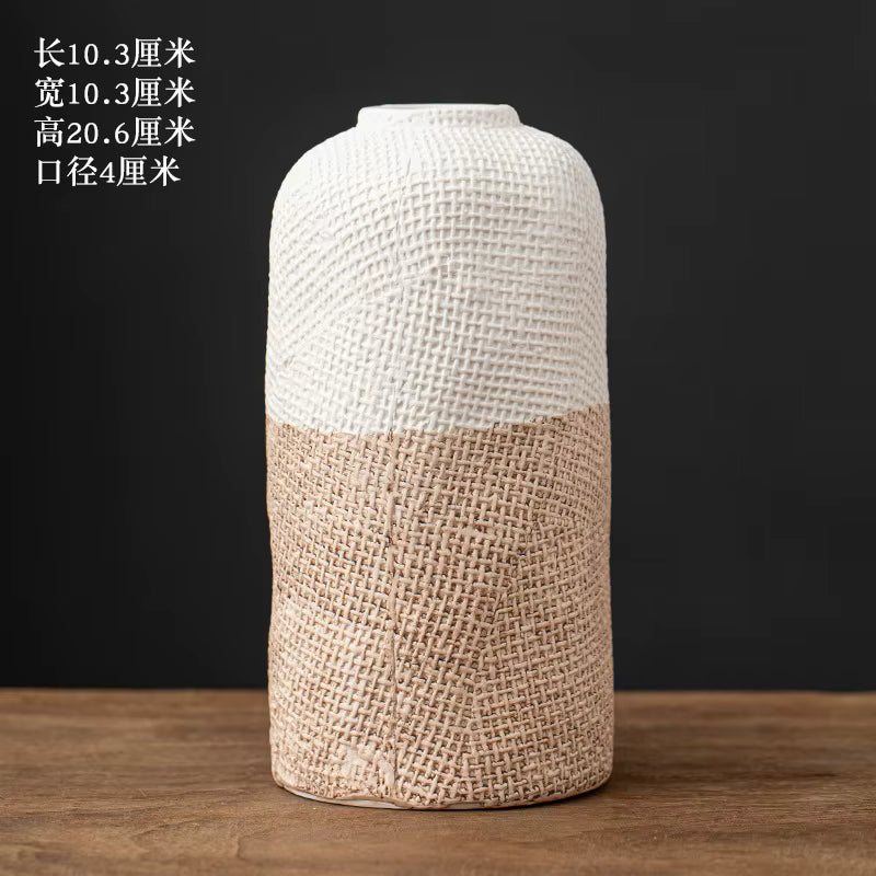 Decorative vase with textured design on a wooden surface and dark background