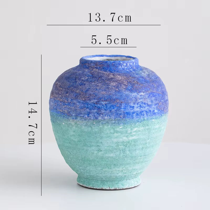 Ceramic vase with blue and green gradient on a white background, showing measurements.