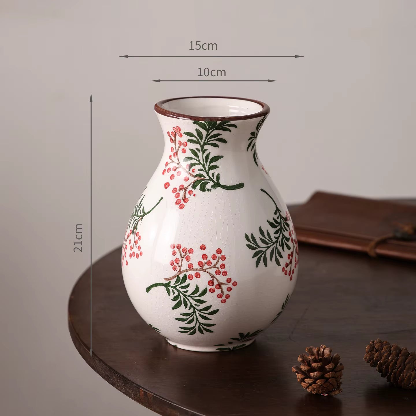 Decorative vase with floral patterns on a wooden surface, shown with measurements.