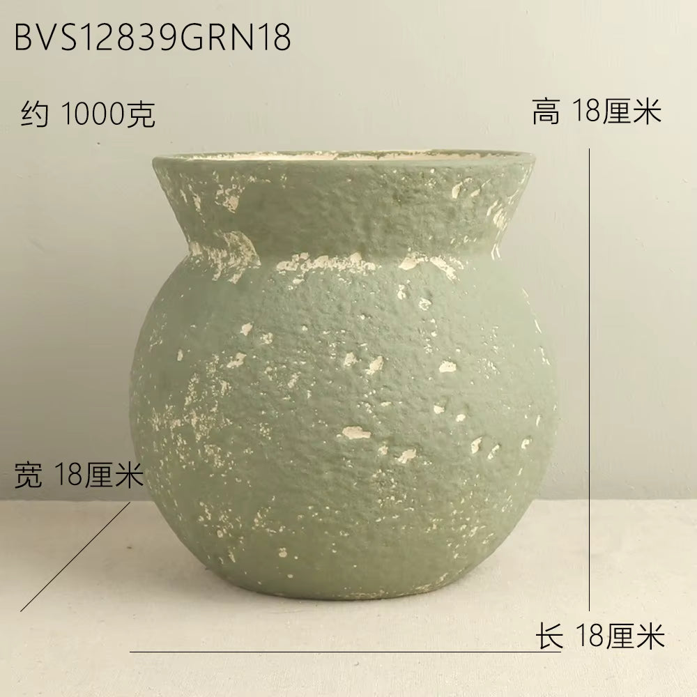 Green ceramic pot with measurements on a light gray background