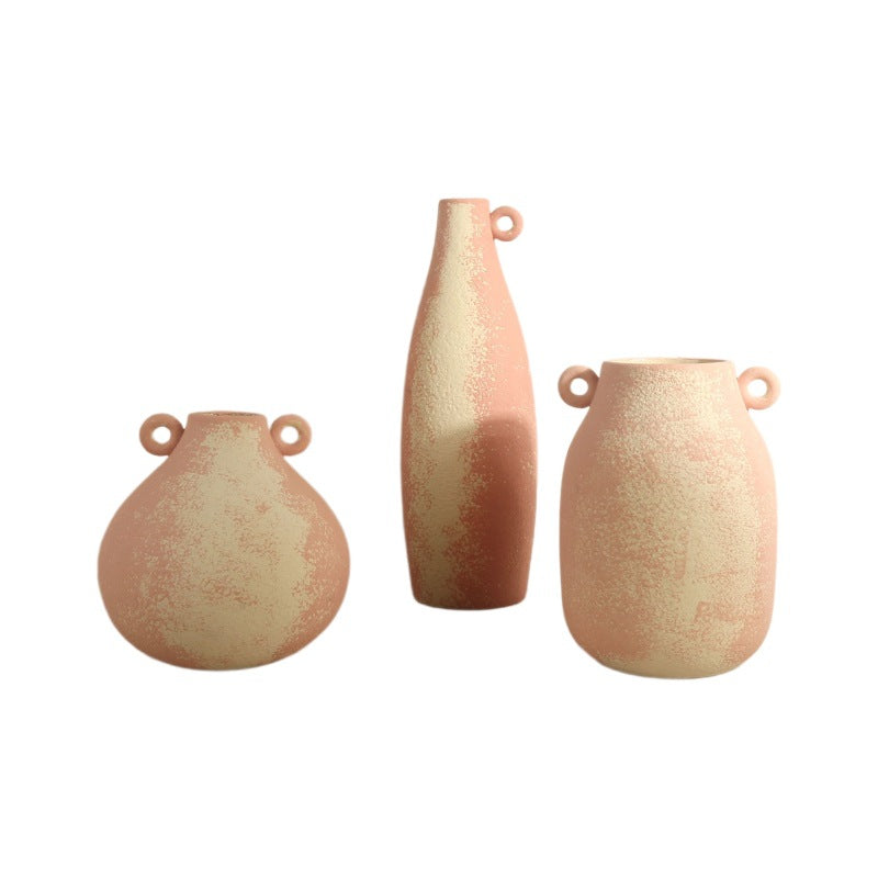 Three ceramic vases with textured surface on a white background