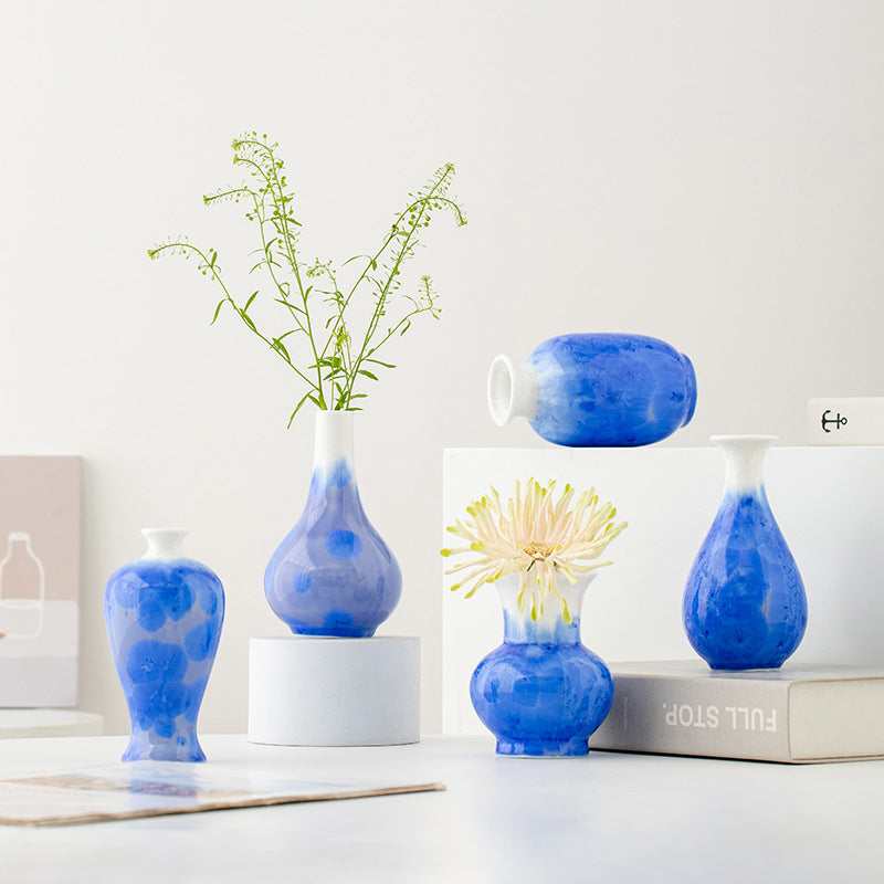 Collection of blue ceramic vases with a white background