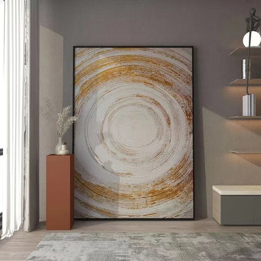 Abstract circular artwork in a modern interior setting with a lamp and small plant.