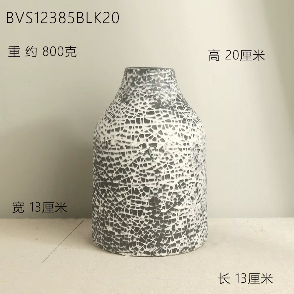 Decorative vase with mosaic pattern on a plain background