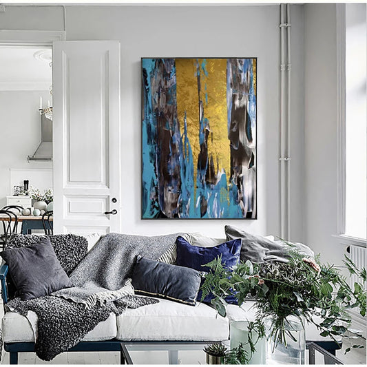 Living room with a large abstract painting on the wall, a white sofa with decorative pillows, and a glass coffee table with plants.