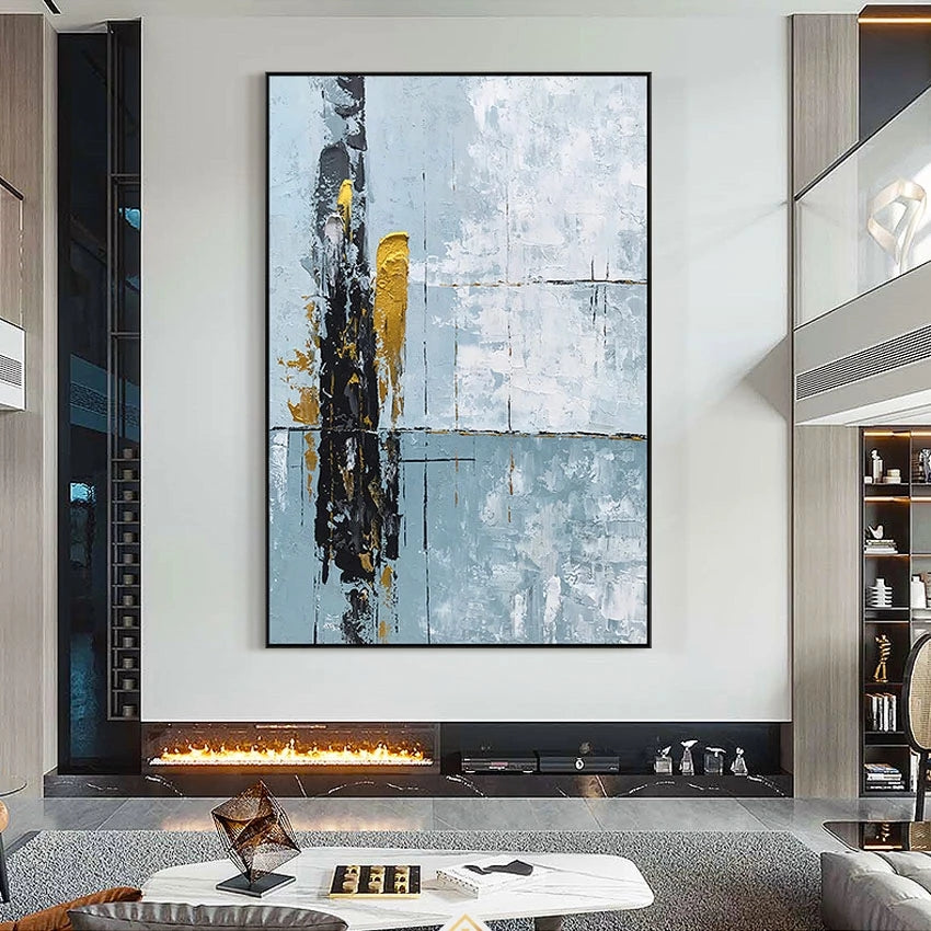 Abstract art piece on a wall above a fireplace in a modern living room.