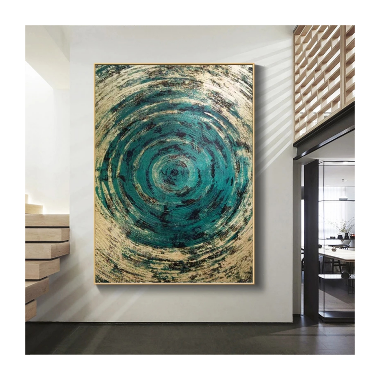 Abstract art painting with concentric circular patterns in teal and beige on a white wall.