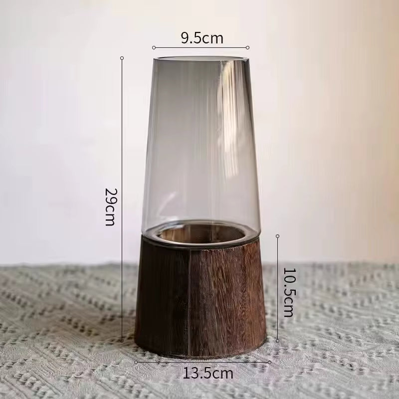 Glass candle holder with wooden base and measurements on a textured surface