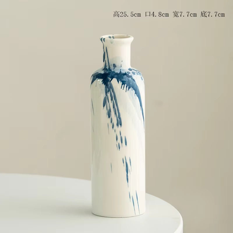 White vase with blue abstract patterns on a beige background
