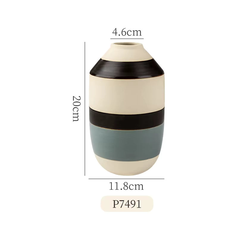 Ceramic vase with color-block design and measurements on a white background