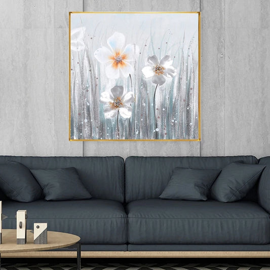 Framed floral artwork above a dark gray sofa in a living room setting.