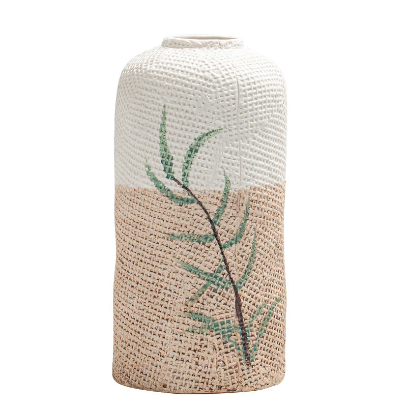 Textured vase with leaf design on a white background